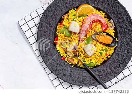 Seafood paella on a black plate, no people, Seafood paella on a black plate, no people, 137742223