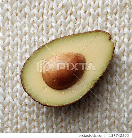 Fresh avocado half with white Warm Knitted texture Creative concept 137742293