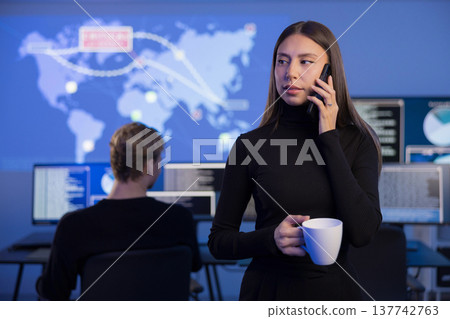 Cybersecurity analysts working in a SOC monitoring threats and incidents 137742763