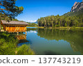 Wooden boat house on the small alpine lake, Dolomites, Italy 137743219