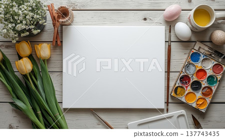 A blank white canvas on a rustic wooden table, with watercolors, flowers, and Easter decor. Concept art, education, DIY creativity, Easter decor. A blank white canvas on a rustic wooden table, with watercolors, flowers, and Easter decor. Concept art, education, DIY creativity, Easter decor. 137743435