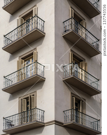 Symmetrical Corner Apartment Balconies With Shuttered Windows On Minimalist Urban Building Facade Symmetrical Corner Apartment Balconies With Shuttered Windows On Minimalist Urban Building Facade 137743556