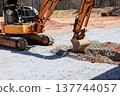 Heavy machinery digs hole at construction site 137744057