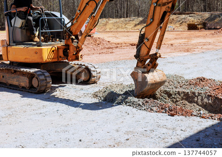 Heavy machinery digs hole at construction site 137744057