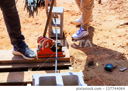 Workers use pulley system to cutting of reinforcement at construction site Workers use pulley system to cutting of reinforcement at construction site 137744064