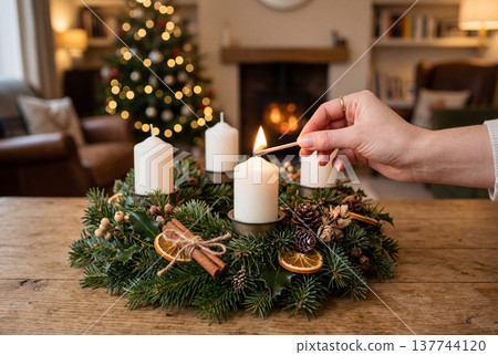 Lighting a candle on an advent wreath at christmas 137744120