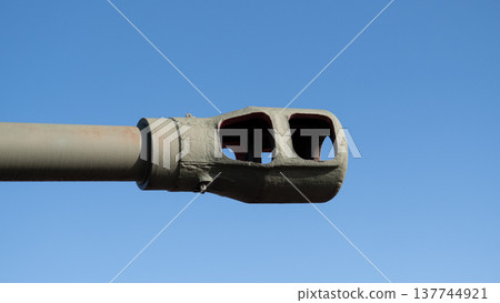 Closeup Tank Barrel Muzzle Against Blue Sky, Weathered Green Paint With Pink Ring, Visible Chipped Coating, Textured Metal Surface, Sunlight Highlighting Edges, Museum Inspection Mood Closeup Tank Barrel Muzzle Against Blue Sky, Weathered Green Paint With Pink Ring, Visible Chipped Coating, Textured Metal Surface, Sunlight Highlighting Edges, Museum Inspection Mood 137744921