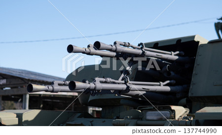 Multiple Gun Barrels On Turret Pointing Forward, Closeup Of Heavy Multibarrel Assembly With Visible Muzzles And Targeting Optics, Industrial Metal Finish And Mechanical Detail Conveying 137744990