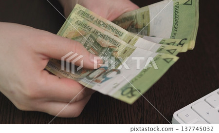 Online Seller Processes Payments Quickly. Arranging Cash Alongside Keyboard During Order Packing. Seller Organizing Cash And Preparing Shipments Efficiently In Busy Home Workspace Online Seller Processes Payments Quickly. Arranging Cash Alongside Keyboard During Order Packing. Seller Organizing Cash And Preparing Shipments Efficiently In Busy Home Workspace 137745032