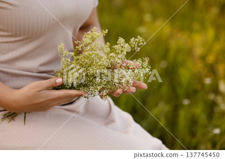 Expectant Mother Gently Enfolds Wildflower Bouquet As Sunlight Warms Her Peaceful Surroundings Expectant Mother Gently Enfolds Wildflower Bouquet As Sunlight Warms Her Peaceful Surroundings 137745450
