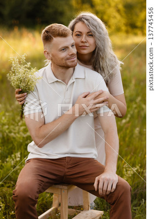 Composed Pair Enjoying Gentle Moments Together Amidst Luminous Natural Surroundings With Warm Hues Composed Pair Enjoying Gentle Moments Together Amidst Luminous Natural Surroundings With Warm Hues 137745456