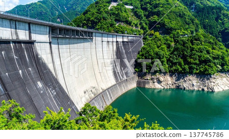日本的水壩和鬱鬱蔥蔥的水庫。基礎設施背景素材，包括混凝土牆和留白區域。 137745786