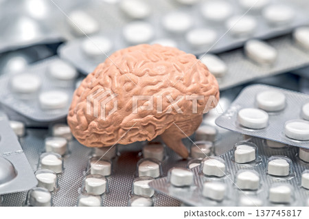Human brain on heap of many various pills and tablets packs 137745817
