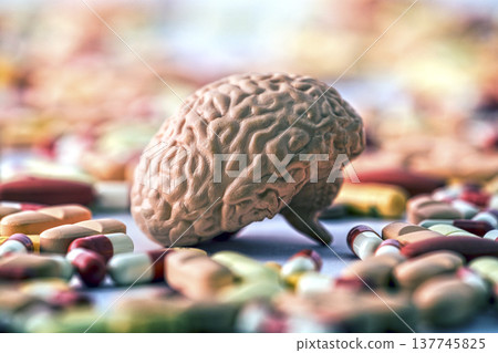 Human brain on heap of medicine pills or dietary supplements 137745825