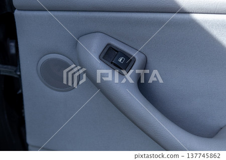 A stylish car door card, highlighting the door handle and speaker, reflecting a blend of comfort and functionality 137745862