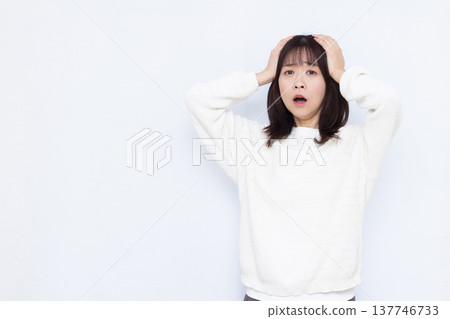 Surprised woman holding her head Surprised woman holding her head 137746733