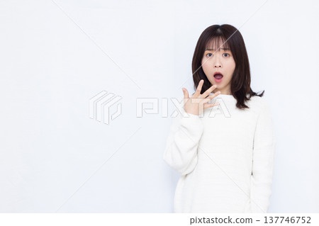 Surprised and amazed woman 137746752