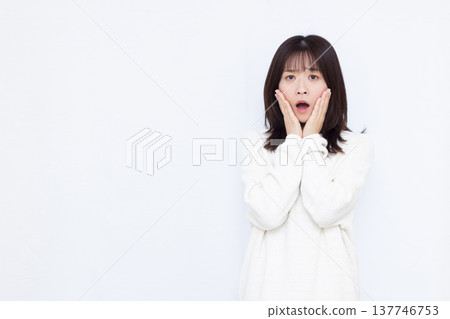 Surprised and amazed woman 137746753