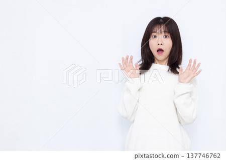 Surprised and amazed woman 137746762