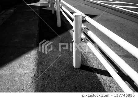 A black and white landscape with guardrails installed on the sidewalk. A black and white landscape with guardrails installed on the sidewalk. 137746996