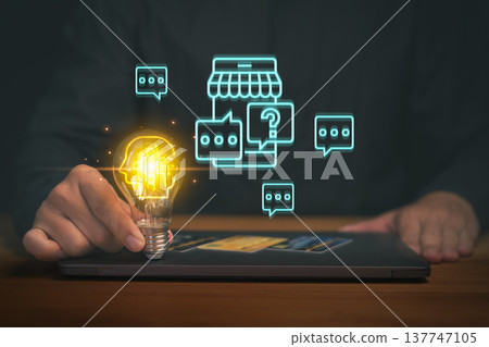Creative idea concept for online business and ecommerce support. Hand holding glowing light bulb on digital tablet with chat icon, innovation, customer service, startup and digital marketing strategy. Creative idea concept for online business and ecommerce support. Hand holding glowing light bulb on digital tablet with chat icon, innovation, customer service, startup and digital marketing strategy. 137747105