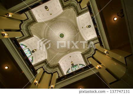 A beautiful Neo-Renaissance style white dome ceiling with stained glass. A beautiful Neo-Renaissance style white dome ceiling with stained glass. 137747131