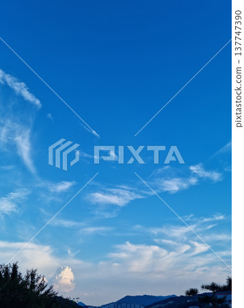 It's a blue sky with fluffy clouds. It's a blue sky with fluffy clouds. 137747390