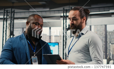 Businessmen analysts monitoring efficiency insights at the workspace, utilizing analytics to plan forecast for detailed performance metrics and statements, business management. Camera B. Businessmen analysts monitoring efficiency insights at the workspace, utilizing analytics to plan forecast for detailed performance metrics and statements, business management. Camera B. 137747391