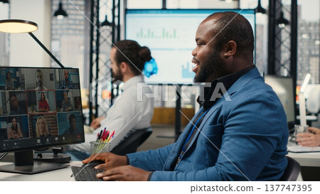 African american CEO meeting with shareholders in advisory video call event, sharing insight on business strategy with numbers through work collaboration. Corporate video conference. Camera B. 137747395