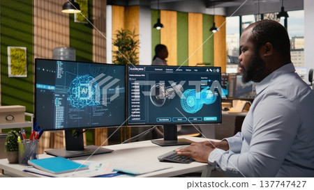 Engineer working on wind turbine simulation in office using artificial intelligence. RD department worker using AI tech and CAD program, doing renewable energy generation engineering, camera A 137747427