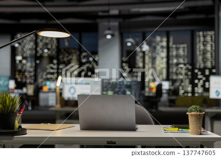 Modern empty office glows with the light of performance metrics and forecasting graphs. Corporate space equipped with technology and computers reflects administration of enterprise objectives. Modern empty office glows with the light of performance metrics and forecasting graphs. Corporate space equipped with technology and computers reflects administration of enterprise objectives. 137747605
