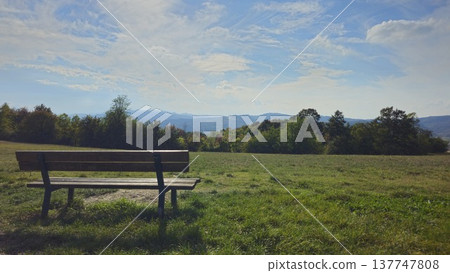 Idyllic Park Bench with Scenic Mountain View 137747808