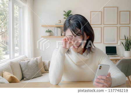 A woman feels sad at home A woman feels sad at home 137748219