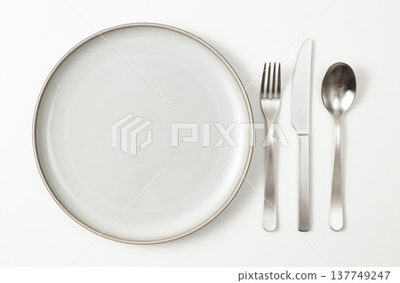 Plates and cutlery against a white background 137749247