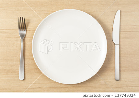 Plates and cutlery on the table 137749324