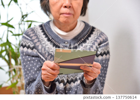 Seniors checking their savings passbook Seniors checking their savings passbook 137750614