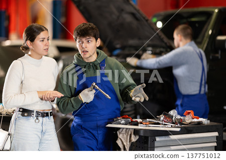 female client listens to recommendations for car repair female client listens to recommendations for car repair 137751012