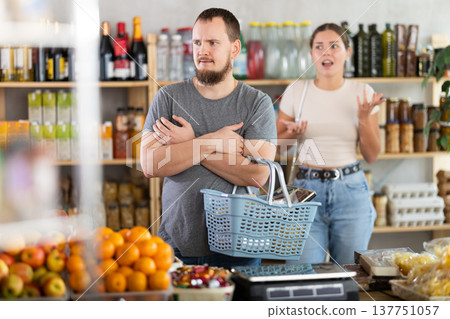 Young woman quarrels with man in grocery store 137751057