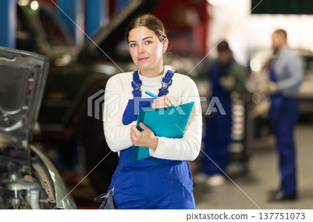 young woman worker invites to the services of a car service young woman worker invites to the services of a car service 137751073