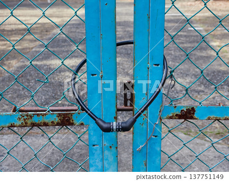 The dilapidated iron gate and combination lock 137751149