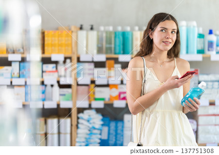 Woman scanning mouthwash 137751308