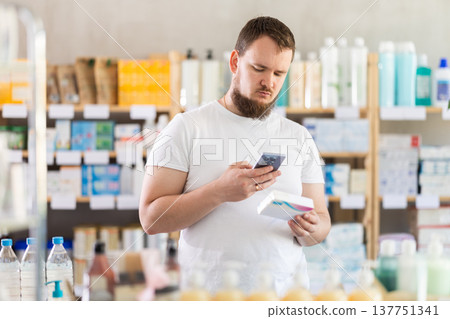Man scans code on package of pills to check expiration date Man scans code on package of pills to check expiration date 137751341