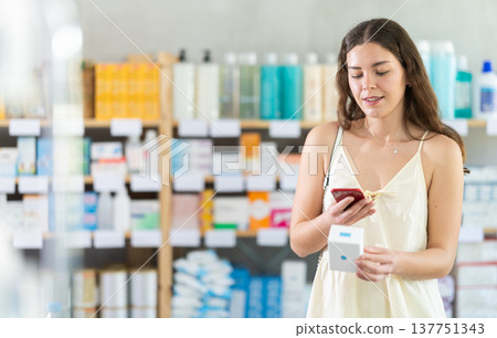 Girl scan barcode on emollient cream in pharmacy 137751343