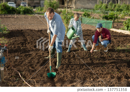 Male farmer with shovel dripping garden 137751358