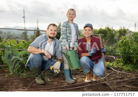Family of farmers standing in the garden Family of farmers standing in the garden 137751757