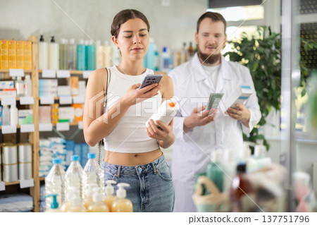 Woman scans QR code on skin creamp label. Male pharmacist offers to choose skin creamp 137751796