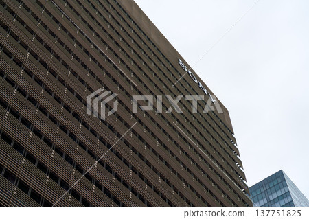 Tokyo, Japan - Sep 30 2024, panoramic view from below of the facade of a multi-storey wide office building in Sony City Osaki, against a cloudy gray sky, at daytime, Tokyo, Japan Tokyo, Japan - Sep 30 2024, panoramic view from below of the facade of a multi-storey wide office building in Sony City Osaki, against a cloudy gray sky, at daytime, Tokyo, Japan 137751825