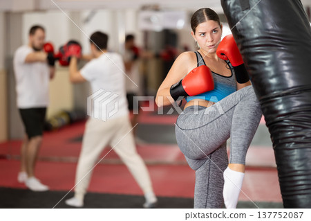 Woman kicking a pear tree 137752087