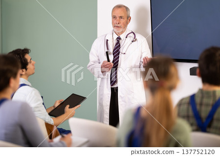 male doctor speaks to students, workers male doctor speaks to students, workers 137752120