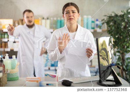 Female pharmacist at the time of dismissal in a pharmacy Female pharmacist at the time of dismissal in a pharmacy 137752368